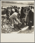 Prospective buyer inspecting a feed grinder at Frank Sheroan's closing-out sale near Montmorenci, Indiana