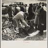 Prospective buyer inspecting a feed grinder at Frank Sheroan's closing-out sale near Montmorenci, Indiana