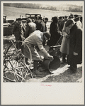 Prospective buyer inspecting a feed grinder at Frank Sheroan's closing-out sale near Montmorenci, Indiana