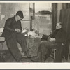 Settling up after the closing-out sale on Frank Sheroan's farm near Montmonenci, Indiana. Mr. Sheroan is shown with the clerk of the sale