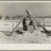 Oscar Gaither, tenant farmer, near McLeansboro, Illinois, hoisting water from his well