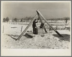 Oscar Gaither, tenant farmer, near McLeansboro, Illinois, hoisting water from his well