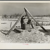 Oscar Gaither, tenant farmer, near McLeansboro, Illinois, hoisting water from his well