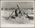Oscar Gaither, tenant farmer, near McLeansboro, Illinois, hoisting water from his well