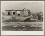 Houseboat washed high and dry amid debris. Maunie, Illinois