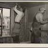 Installing wallboard in a house at the Greenhills project, Ohio. Note sound proofing and insulation