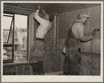 Installing wallboard in a house at the Greenhills project, Ohio. Note sound proofing and insulation