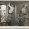 Installing wallboard in a house at the Greenhills project, Ohio. Note sound proofing and insulation