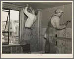 Installing wallboard in a house at the Greenhills project, Ohio. Note sound proofing and insulation