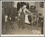 One of Erasty Emvich's sons weaving a rug in farmhouse near Battle Ground, Indiana. Mr. Emvich, tenant farmer and father of twelve children, also weaves in his spare time