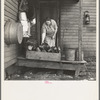 Mrs. Tip Estes, wife of a hired man and mother of nine children, bringing in fuel from the back porch. Near Fowler, Indiana