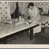 7 a.m. Mrs. Tip Estes, wife of a hired man near Fowler, Indiana, preparing lunches for the five of her nine children who go to school