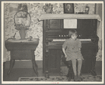 7:45 p.m. After dinner the family sits around in the living room. This is one of the daughters sitting on the stool for the organ (which does not work). Tip Estes family near Fowler, Indiana