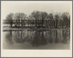 The home of an island farmer on the Illinois River near Ottawa, Illinois. Note graveyard on the opposite bank