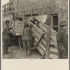 Preparing to unload cattle from a farmer's wagon at the sales pavilion. Aledo, Illinois