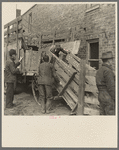 Preparing to unload cattle from a farmer's wagon at the sales pavilion. Aledo, Illinois