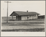 The old Louisville and Nashville Railroad station after the flood. Shawneetown, Illinois. Note flood marks on building