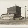 Old flour mill damaged by the flood. Note wrought iron streetlight fixture. Shawneetown, Illinois