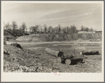 Spillway part of earthen dam with logs and debris from land which has been cleared. Martin County Development Project, Indiana