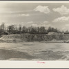 Spillway end of earthen dam from small hill in basin. Martin County Development Project, Indiana