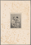 Portrait of a man and young boy standing next to him
