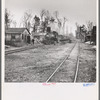The log train passes through the lumber camp en route to Rhinelander, Wisconsin, where the sawmill of the lumbercamp is located. Forest County, Wisconsin