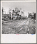 The log train passes through the lumber camp en route to Rhinelander, Wisconsin, where the sawmill of the lumbercamp is located. Forest County, Wisconsin