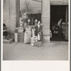 Woman sitting in front of a grocery store. Shawneetown, Illinois