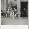 Woman sitting in front of a grocery store. Shawneetown, Illinois