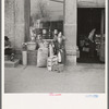Woman sitting in front of a grocery store. Shawneetown, Illinois