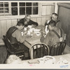 Men eating in the transient camp at Hagerman Lake, Michigan. This is a former lumber camp