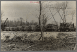 A trainload of timber recently cut and ready to be shipped to the sawmill. Little effort is made to clean up after cutting timber. Note slashings and brush in foreground. Wisconsin