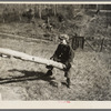 One of the Max Sparks' children playing on homemade teeter-totter near Long Lake, Wisconsin