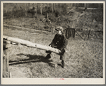 One of the Max Sparks' children playing on homemade teeter-totter near Long Lake, Wisconsin