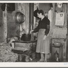 Mrs. Lon Allen stirring the soup in her home near Iron River, Michigan