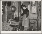 Mrs. Lon Allen stirring the soup in her home near Iron River, Michigan