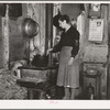 Mrs. Lon Allen stirring the soup in her home near Iron River, Michigan