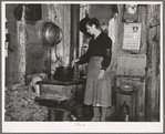 Mrs. Lon Allen stirring the soup in her home near Iron River, Michigan