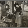 Mrs. Lon Allen stirring the soup in her home near Iron River, Michigan