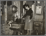 Mrs. Lon Allen stirring the soup in her home near Iron River, Michigan