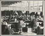 Interior of cooperative garment factory at Jersey Homesteads, showing some of the eighty homesteaders at their work and some of the ladies' coats made by them. Hightstown, New Jersey