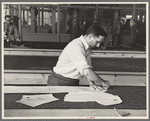 Louis Gushen, chief cutter in the cooperative garment factory at Jersey Homesteads, marks out the pattern of a woman's coat, which will be made in the factory, Hightstown, New Jersey