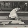 Louis Gushen, chief cutter in the cooperative garment factory at Jersey Homesteads, marks out the pattern of a woman's coat, which will be made in the factory, Hightstown, New Jersey