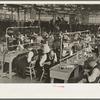 Interior of cooperative garment factory at Jersey Homesteads, showing some of eighty homesteaders at their work and some of the ladies' coats made by them. Hightstown, New Jersey