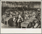 Interior of cooperative garment factory at Jersey Homesteads, showing some of eighty homesteaders at their work and some of the ladies' coats made by them. Hightstown, New Jersey