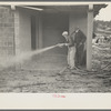 Whitewashing a cinderblock house, Jersey Homesteads, Hightstown, New Jersey
