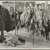 Half-made garments on the racks, awaiting final operations of the machines, in cooperative garment factory, Hightstown, New Jersey