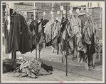 Half-made garments on the racks, awaiting final operations of the machines, in cooperative garment factory, Hightstown, New Jersey