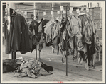 Half-made garments on the racks, awaiting final operations of the machines, in cooperative garment factory, Hightstown, New Jersey