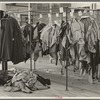 Half-made garments on the racks, awaiting final operations of the machines, in cooperative garment factory, Hightstown, New Jersey